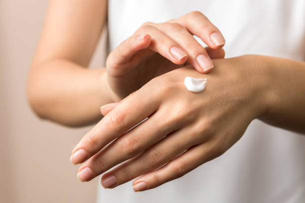 skincare. close up view of woman hand moisturising them with cream. skincare skincare. close up view of woman hand moisturising them with cream. skincare. applying stock pictures, royalty-free photos & images