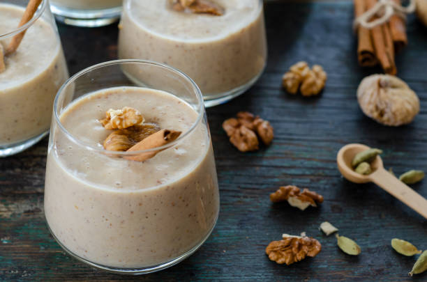 Milky fig dessert Milky fig dessert in the glass on wooden table. cardamom stock pictures, royalty-free photos & images