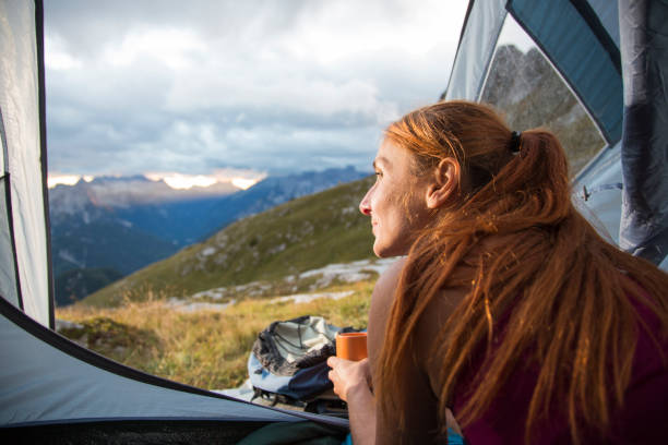istock Woman camping in the mountains 1200590385