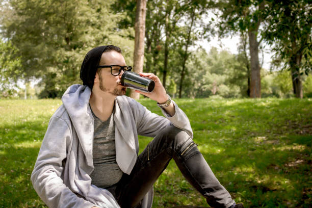 istock Casual man drinking takeaway coffee in the park. 1200594168