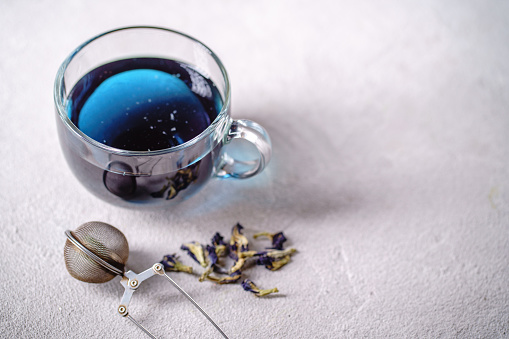 Pea tea, butterfly blue tea in glass mug, herbal detox drink. Anchan. Herbal hot or cold beverage