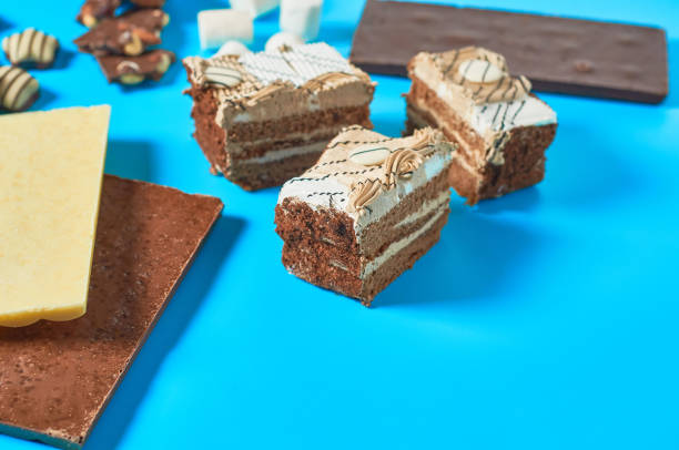 istock Various sweets cake, candies, marshmallow, chocolate bar lies on blue table on party. Celebration concept. Space for text 1200594469