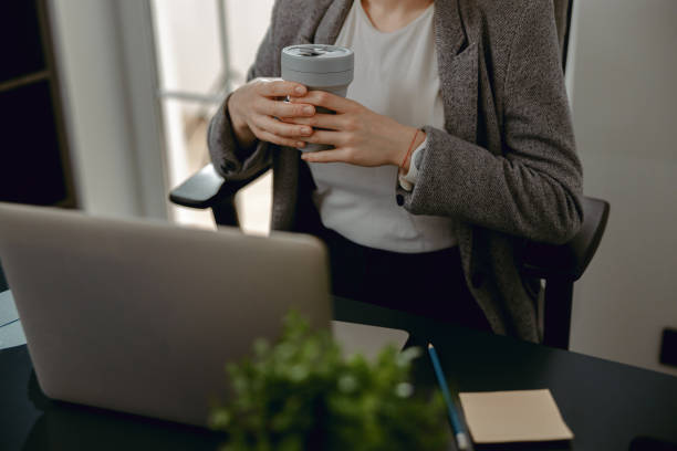 istock Female hands holding hot drink and resting 1200597085