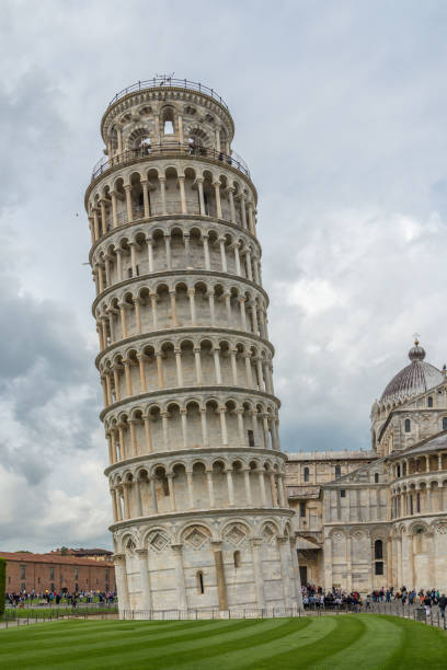 Leaning Tower of Pisa The Leaning Tower of Pisa is a bell tower surrounded by visitors and tourists near the cathedral in the Italian city of Pisa blind arcade stock pictures, royalty-free photos & images