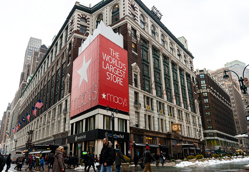 New York City, USA - February 18, 2014: Macy's Herald Square Store which is the flagship store for Macy's located on Herald Square in Manhattan, New York City. People and cars moving alongside the street.
