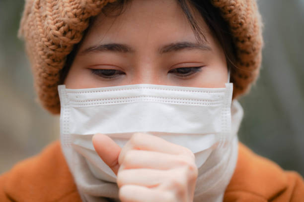 istock a young woman wearing a mask in winter 1200600841