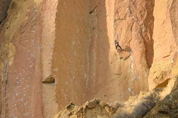istock Rock climbers climb a large rock, filmed from the back. 1200603885