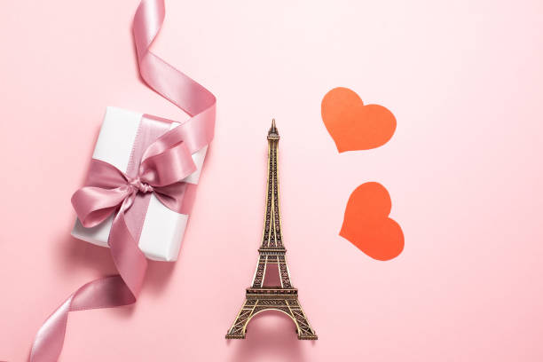 istock Small Eiffel Tower flat lay on pink background. Valentines day 1200604241