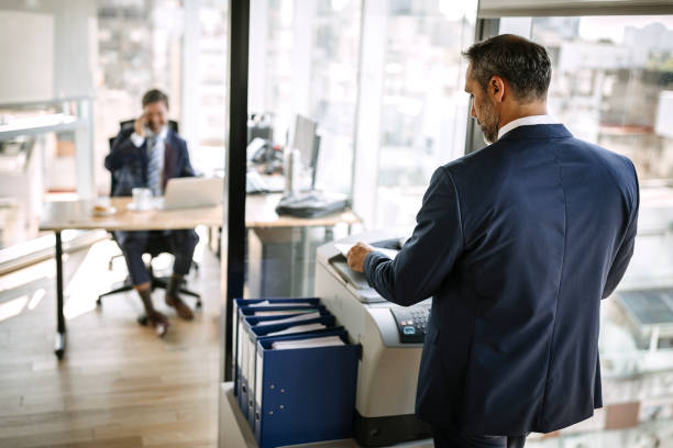 Businessman taking print out in office