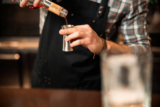 istock Barman pouring a drink into a measuring cup 1200606636