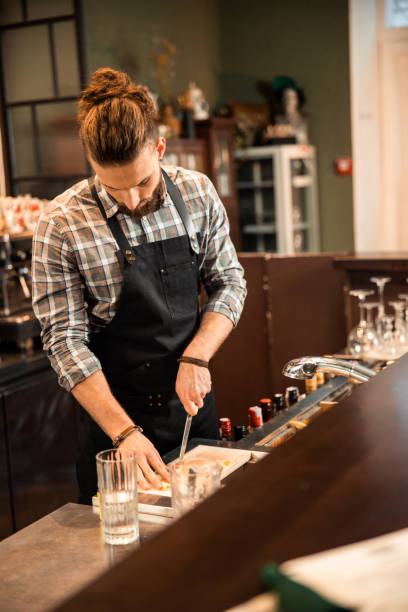 istock Young bearded barman preparing ingredients for drinks 1200606657