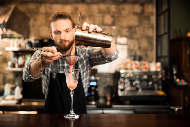istock Male bearded bartender is making fancy cocktail 1200606715