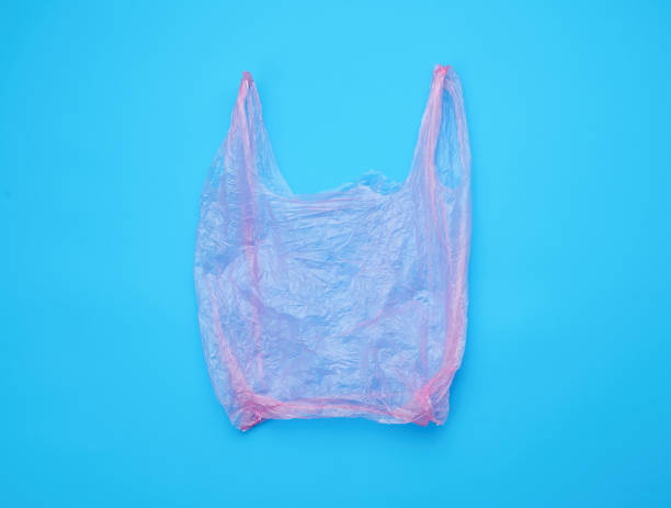 istock open empty plastic pink bag for products on a blue background 1200607580