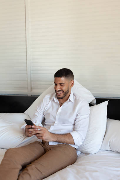 istock young travel entrepreneur converting by video chat in a hotel bed 1200607653