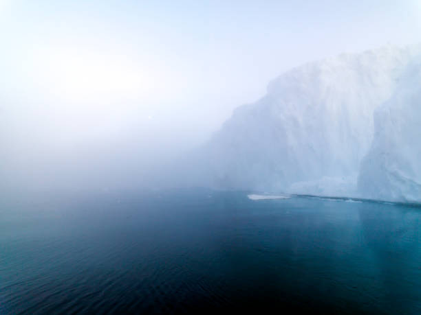 Arctic glacier in arctic ocean, greenland. Climate change in arctic circle. Foggy day in Ilulissat