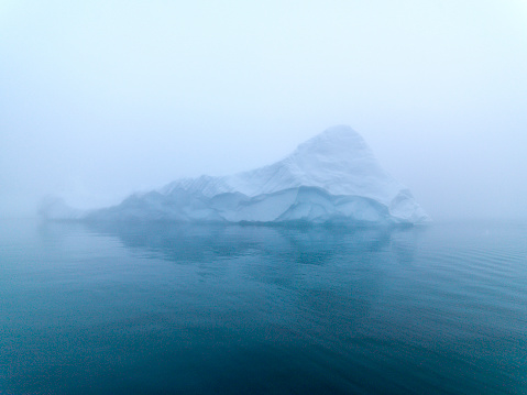Arctic glacier in arctic ocean, greenland. Climate change in arctic circle. Foggy day in Ilulissat
