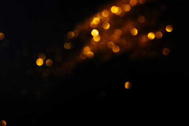 istock Beautiful blurred golden background on black 1200610663