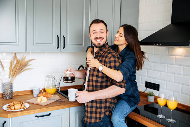 istock Loving couple in a stylish gray kitchen 1200610753