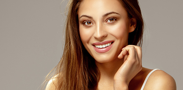 Happy beauty woman looking at the camera.Cheerful young brunette smiling.