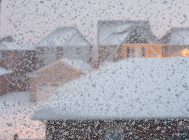 istock Snow storm background - selective focus of snow flakes on window panes 1200617501