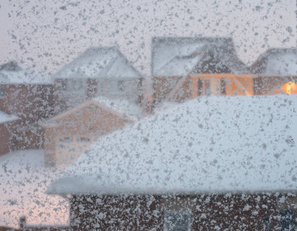 istock Snow storm background - selective focus of snow flakes on window panes 1200618116