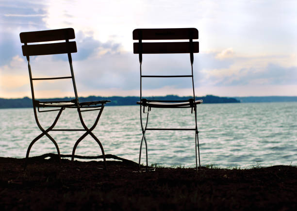 Two chairs near tha lake. Silhouette. Bavaria