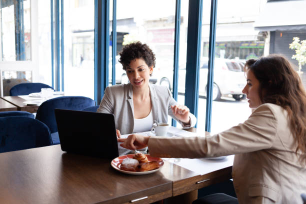 istock 2 young women at a breakfast meeting 1200622990