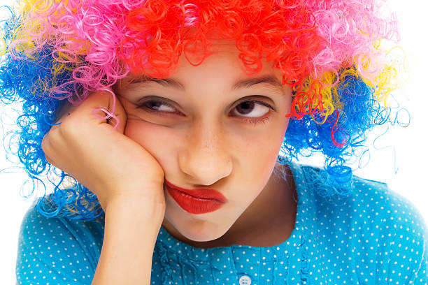 Beautiful young girl with party wig isolated on white background