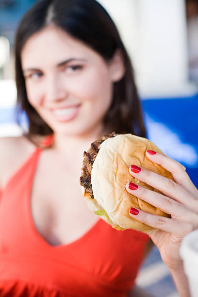 istock girl smiling with hamburger 120063211