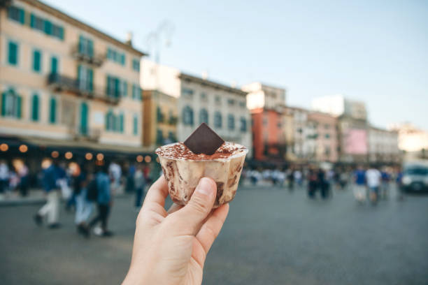 istock Girl holds tiramisu in hand 1200633467