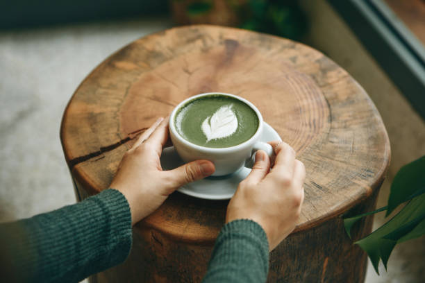 istock Girl drinks matcha latte tea 1200637207