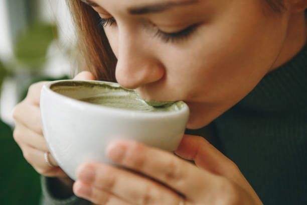 istock Girl drinks matcha latte tea 1200637241