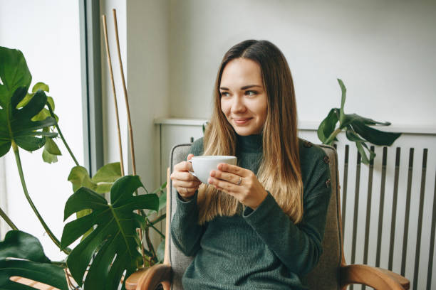 istock Girl drinks a hot drink 1200637243