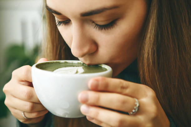 istock Girl drinks matcha latte tea 1200637328