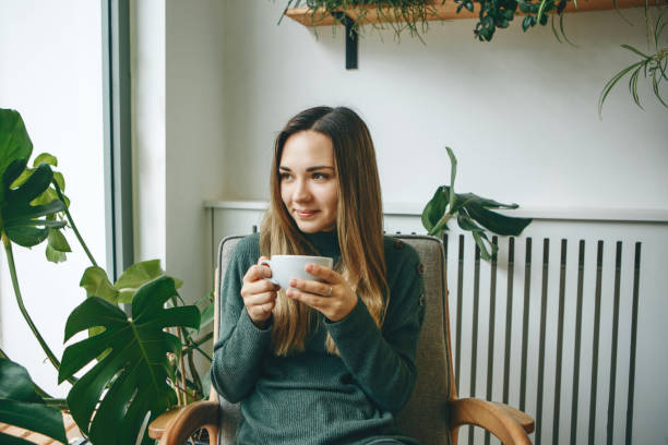 istock Girl drinks a hot drink 1200637349