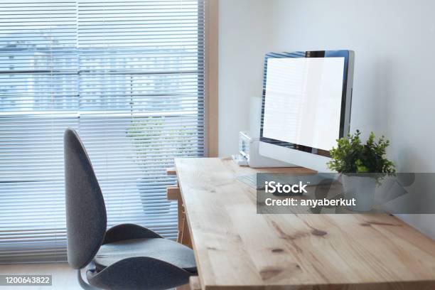 Workspace Interior With Computer On Wooden Table And Office Chair Stock Photo - Download Image Now