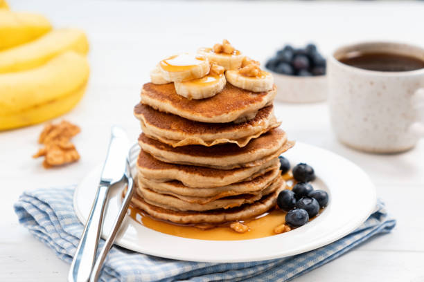 istock Tasty pancakes with banana and syrup 1200644619