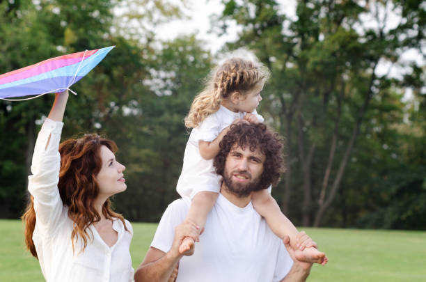istock Happy young family in the park 1200647199
