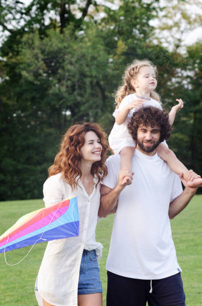 istock Happy young family in the park 1200647227