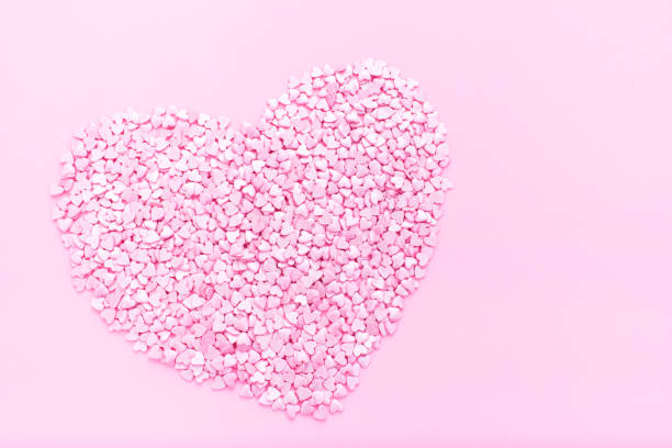 istock Pink background. Pink hearts on a pink background. Hearts sprinkles. 1200656702