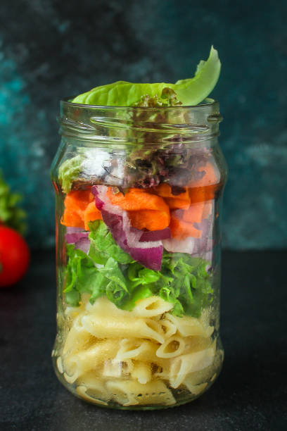 istock healthy salad in a jar (vegetable snack pasta salad) menu concept. food background. top view. copy space 1200657391