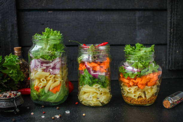 istock healthy salad in a jar (vegetable snack pasta salad) menu concept. food background. top view. copy space 1200657394