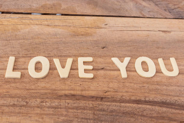 istock Love wooden text on board background. 1200658405