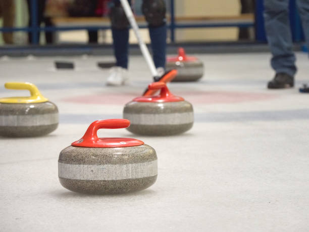 istock Curling stone on ice of a indoors rink. 1200658430