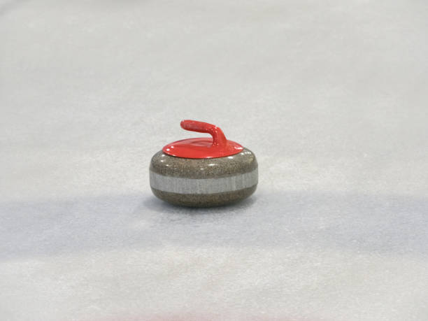 istock Curling rocks on a white and blue rink. 1200658466