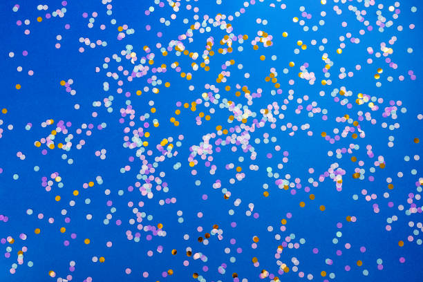 Blue background with confetti. Flat lay stock photo