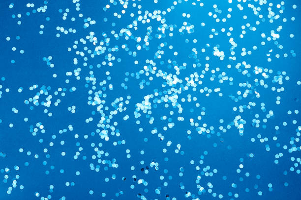 Blue background with confetti. Flat lay stock photo