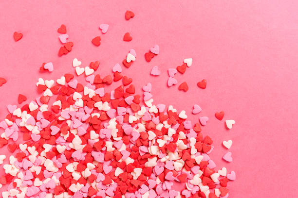Lots of multicolored hearts on pink background for Valentine's day stock photo