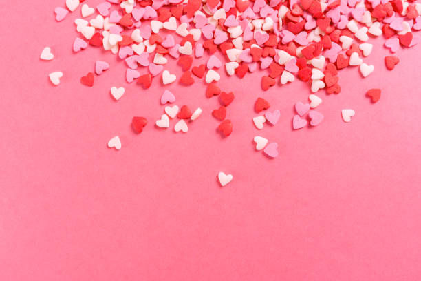 Lots of multicolored hearts on pink background for Valentine's day stock photo
