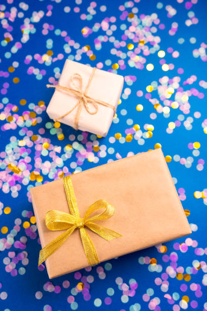 istock Two boxes with gift on blue background with confetti. 1200658560